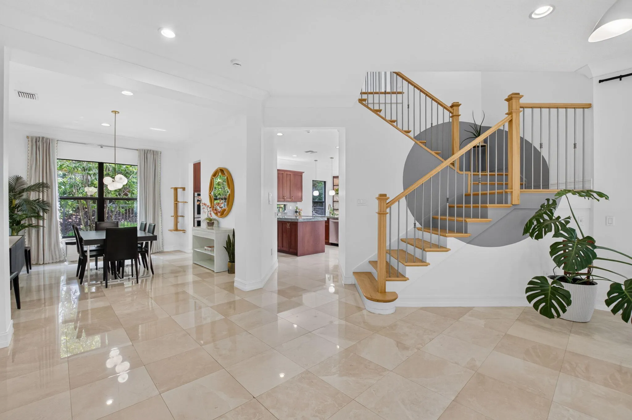 Curved staircase with natural wood treads and metal balusters
