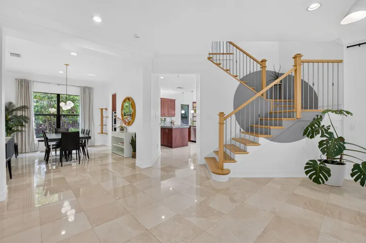 Curved staircase with natural wood treads and metal balusters