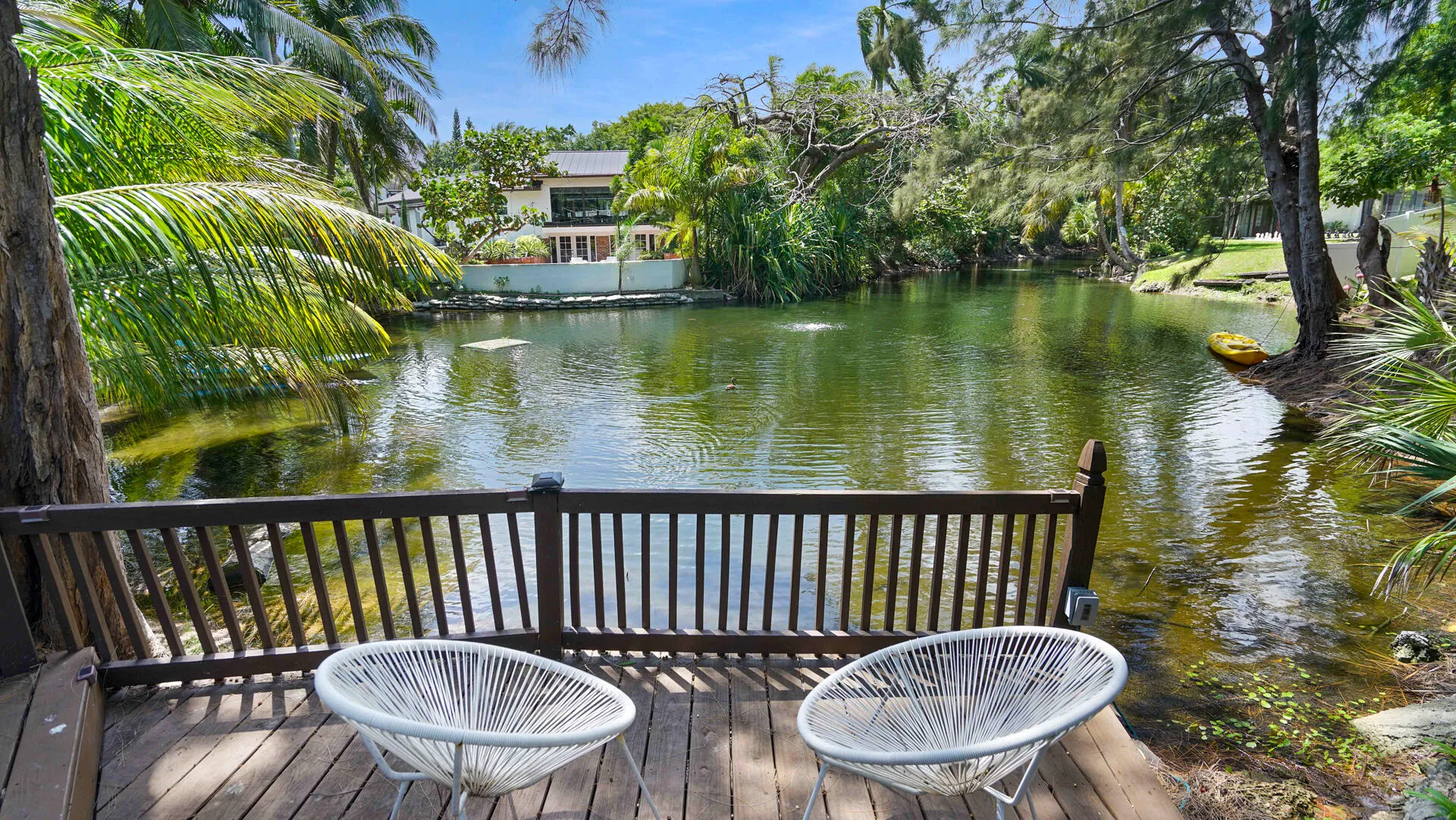 Waterfront deck with wood-finish flooring and a full railing