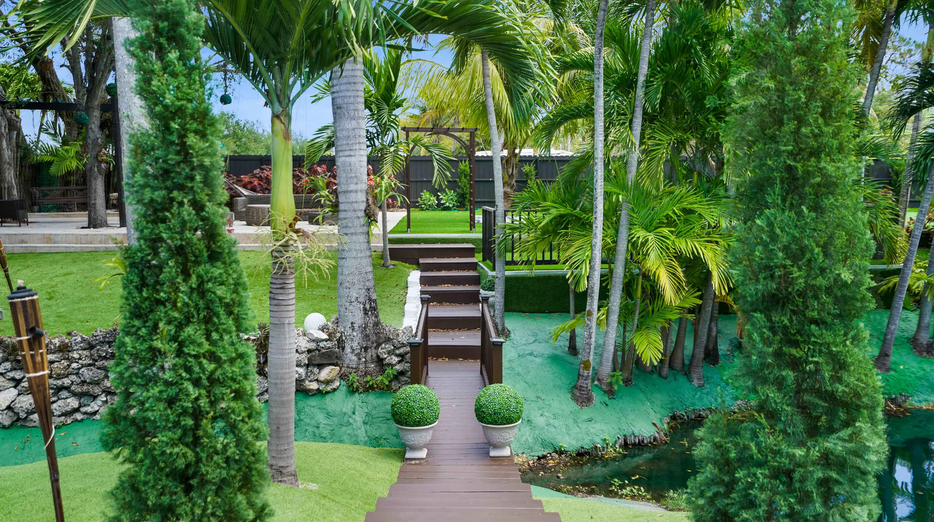 Multi-level exterior space featuring a tiered wood deck and stairs