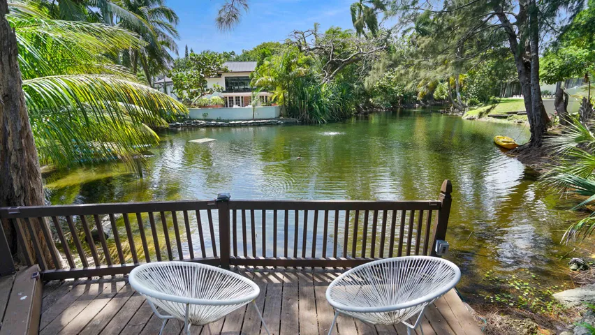 Waterfront deck with wood-finish flooring and a full railing