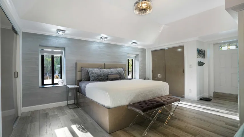 Vaulted ceiling with an ornate semi-flush mount light fixture and additional recessed lighting