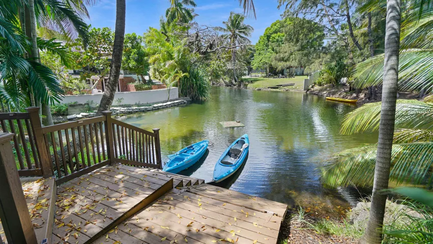 Waterfront property featuring a private wooden deck and stairs to the water