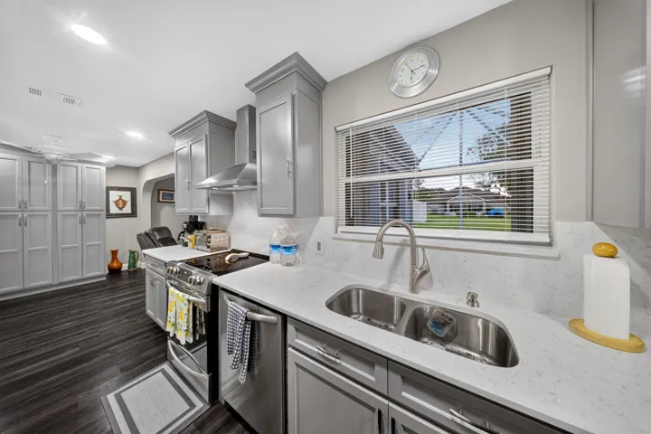 Contemporary kitchen featuring a dual basin stainless steel sink with a gooseneck faucet