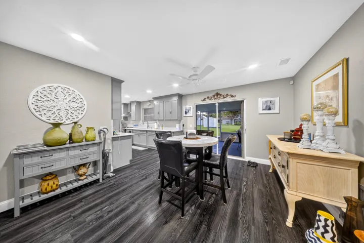 Spacious open-concept living area featuring dark wood-finish flooring and light gray walls