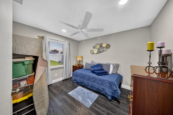Room featuring wood-finish flooring, a ceiling fan with integrated lighting, and recessed ceiling lights