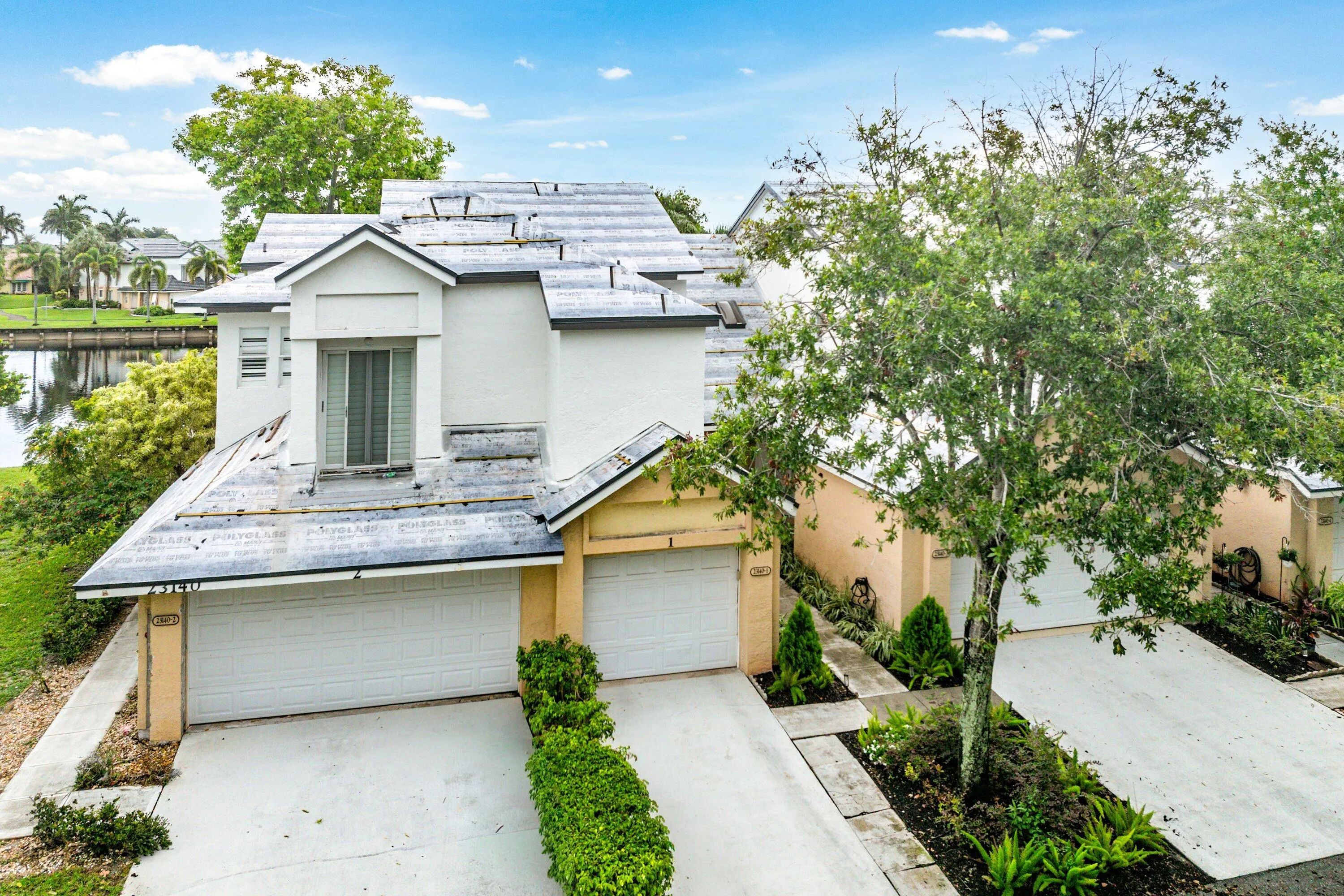 Two-story residence featuring a distinctive roofline and a waterside location