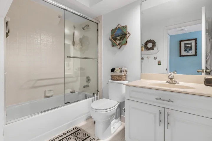 Bathroom featuring a white vanity with cabinet storage, light-colored countertop, and integrated sink