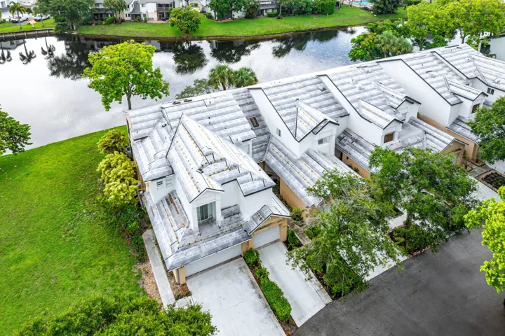Waterfront property featuring a sloped, manicured lawn