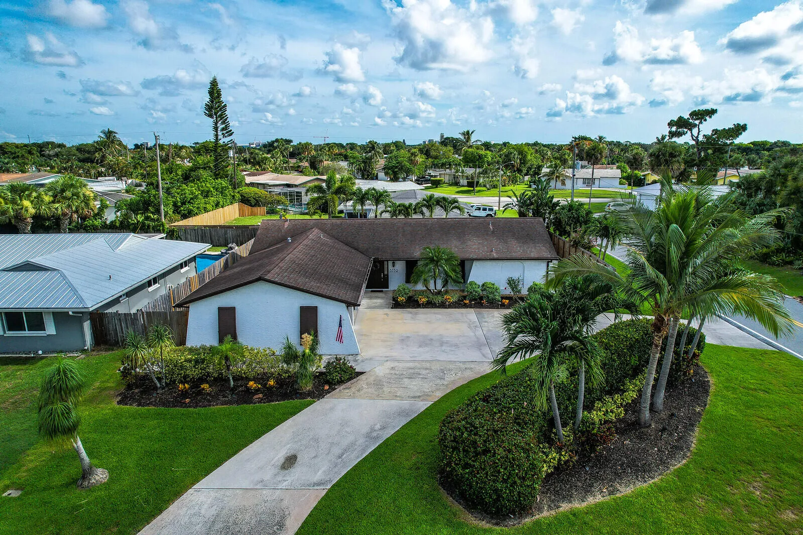 Tropical landscaping with mature palm trees and manicured shrubbery