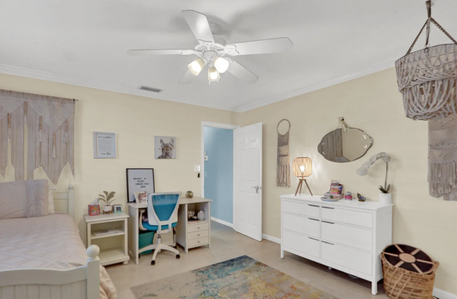 Spacious room featuring neutral wall tones, crown molding, and a ceiling fan with integrated lighting