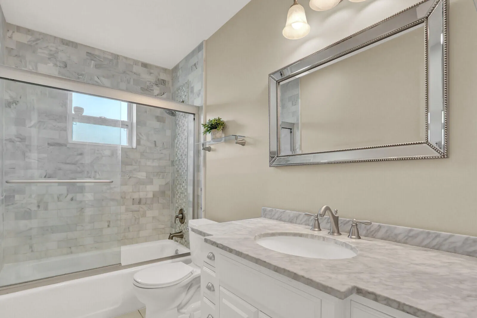 Bathroom featuring a white vanity with a stone countertop, an undermount sink, and brushed nickel fixtures