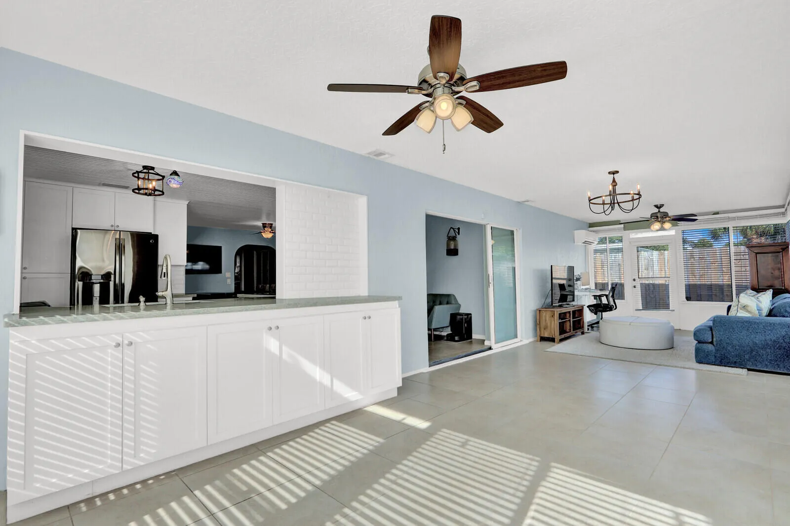 Expansive interior featuring ceramic tile flooring and light blue wall tones