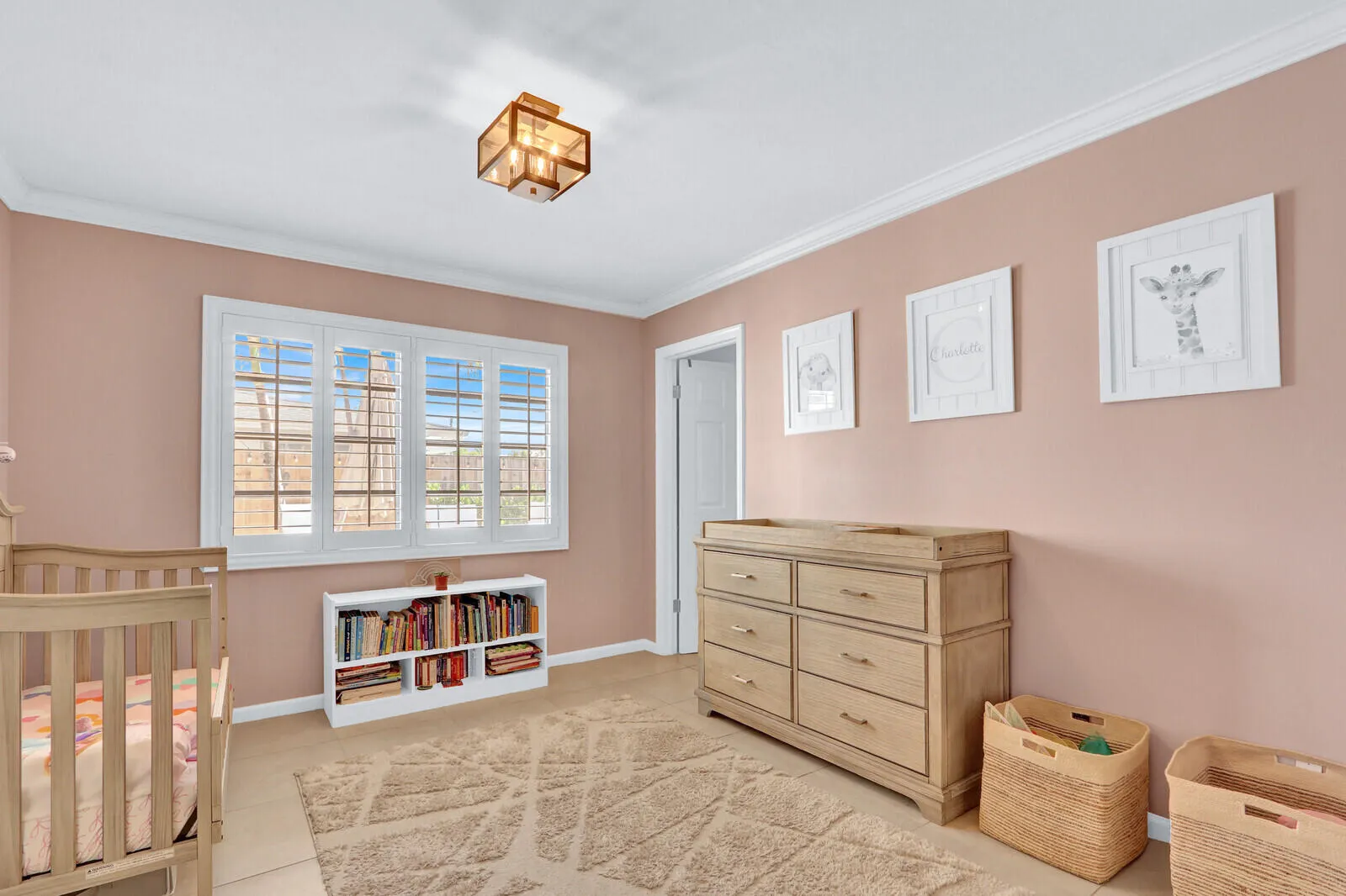 Interior space featuring a four-panel window with plantation shutters, crown molding, and light-toned wall paint