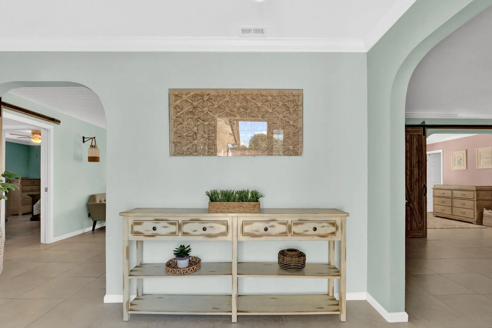 Arched doorways framing a central console table with wood-finish trim and decorative pulls