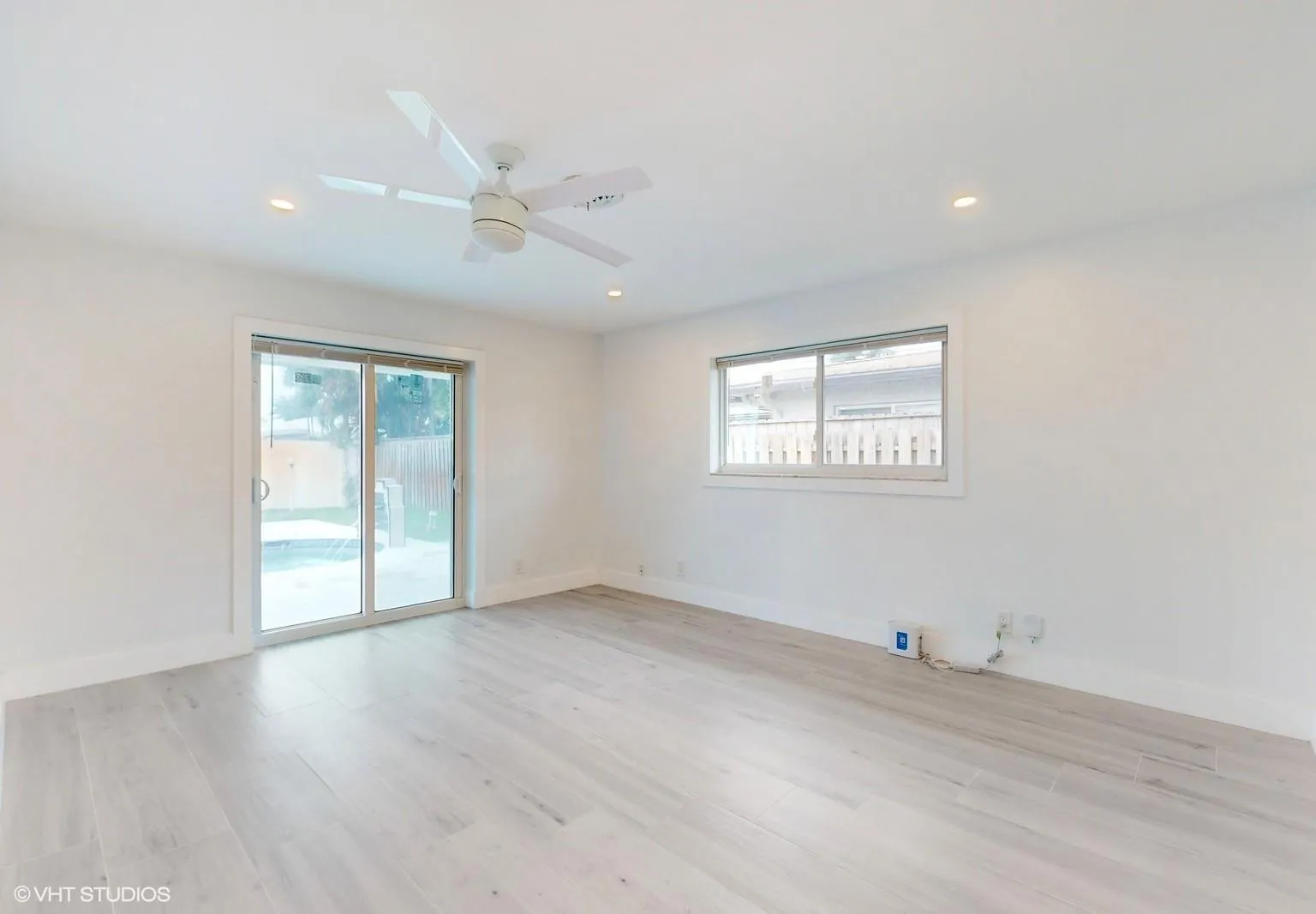 Sliding glass doors in the master bedroom provide4 access to back yard pool and garden area