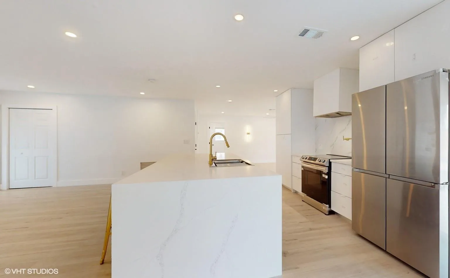 Side view of kitchen with family room in the background