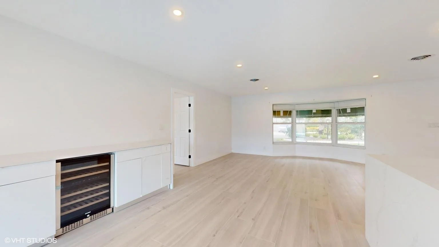 Dining room with built in wine bar and buffet style cabinetry