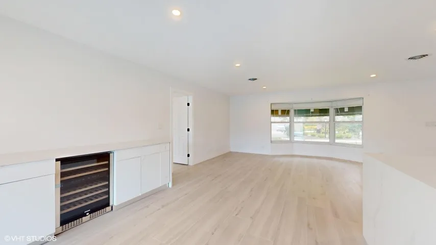 Dining room with built in wine bar and buffet style cabinetry
