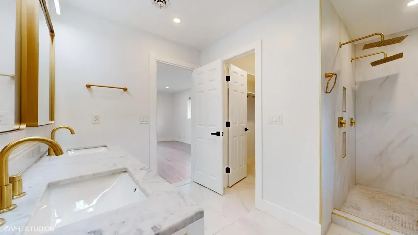 Two faucets, two mirrors and two showers give added flexibility and utilization to this master bathroom