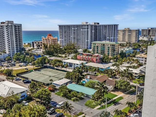 Aerial perspective showcasing a coastal cityscape with the ocean horizon