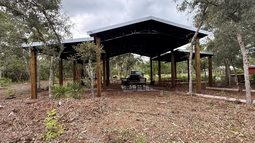 Escape to your own private slice of Florida paradise! Nestled on 2.95 fully fenced acres, this beautifully remodeled and fully furnished 2-bedroom, 2-bath home offers the perfect blend of modern comfort and peaceful country living. Enjoy a gorgeous she shed, pole barn, private pond with dock, walking trails, chicken coops, and nearly three acres of privacy, all on a paved road.