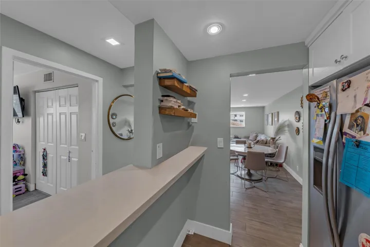 Kitchen opens to entry and dining area