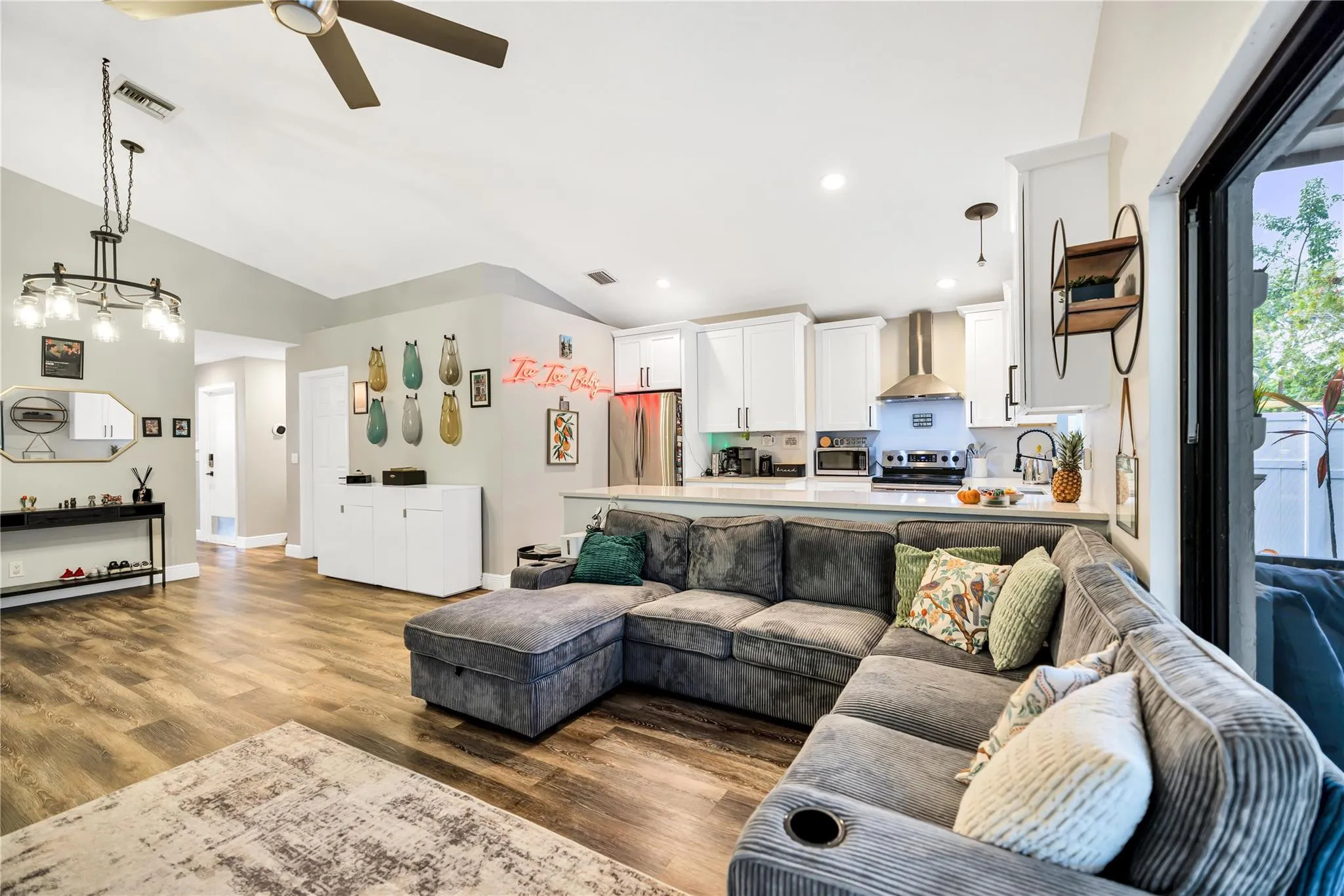 Hallway on left leads to Guest Bathroom, 2 bedrooms, and garage entry.
