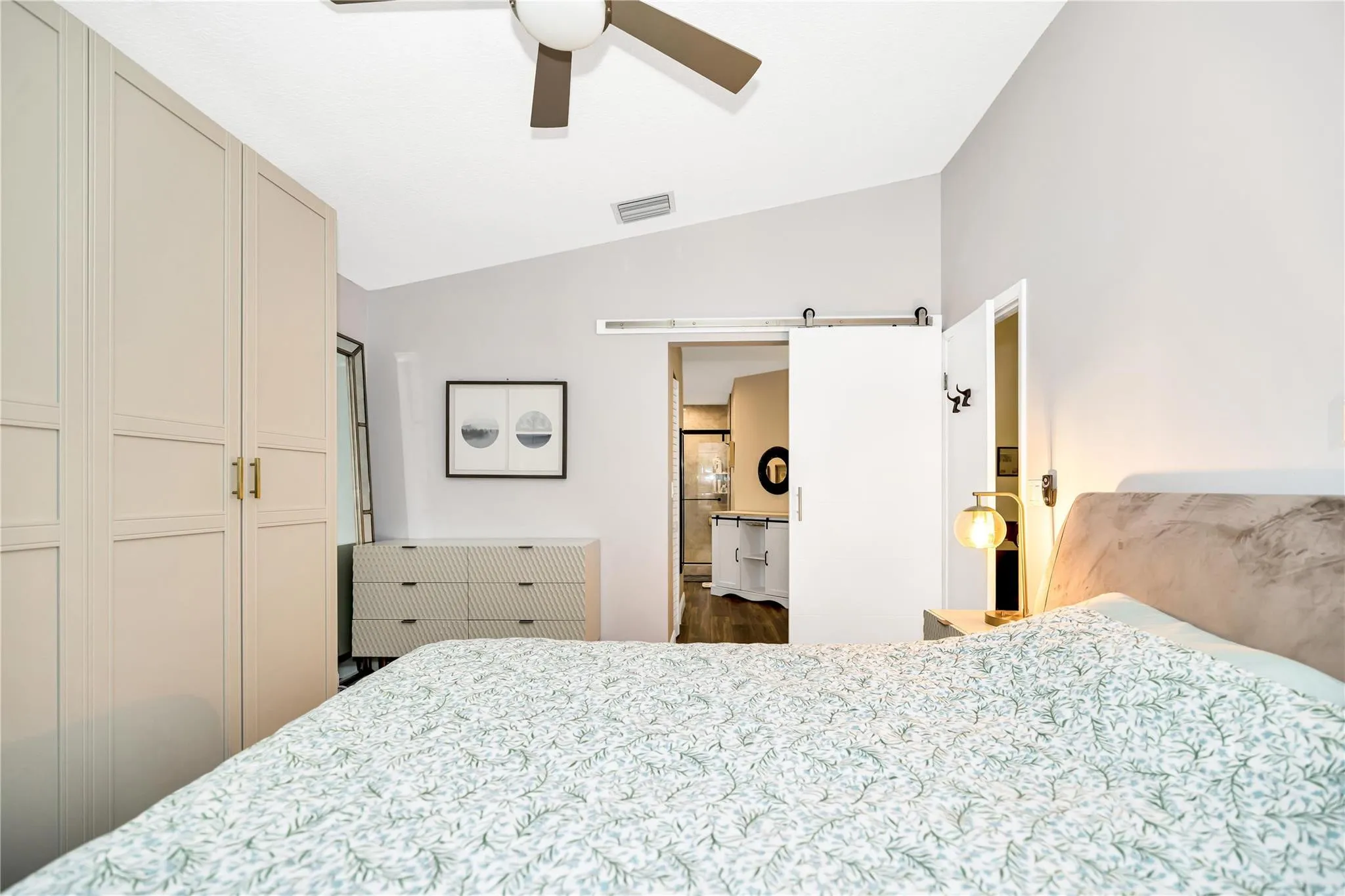 Barn style rolling door leads to Primary ensuite. Exit the bedroom to the right.