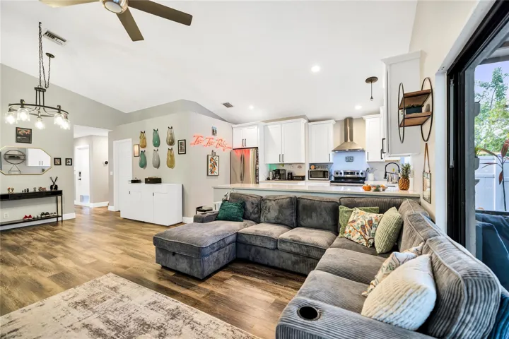 Hallway on left leads to Guest Bathroom, 2 bedrooms, and garage entry.