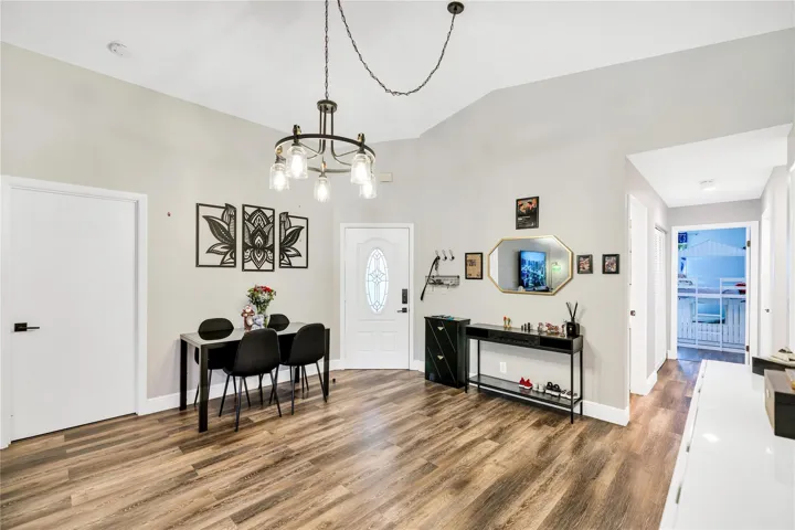 View of Dining area and front Entrance. Hallway on the right lead to 2 bedrooms, door on the left is the primary bedroom.