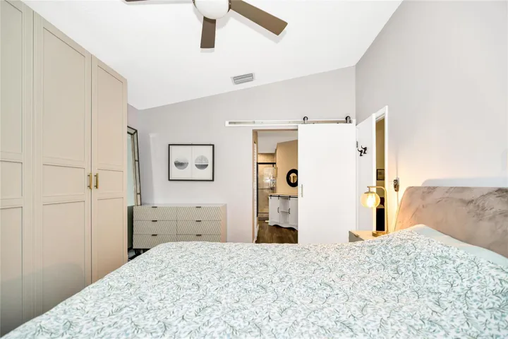 Barn style rolling door leads to Primary ensuite. Exit the bedroom to the right.