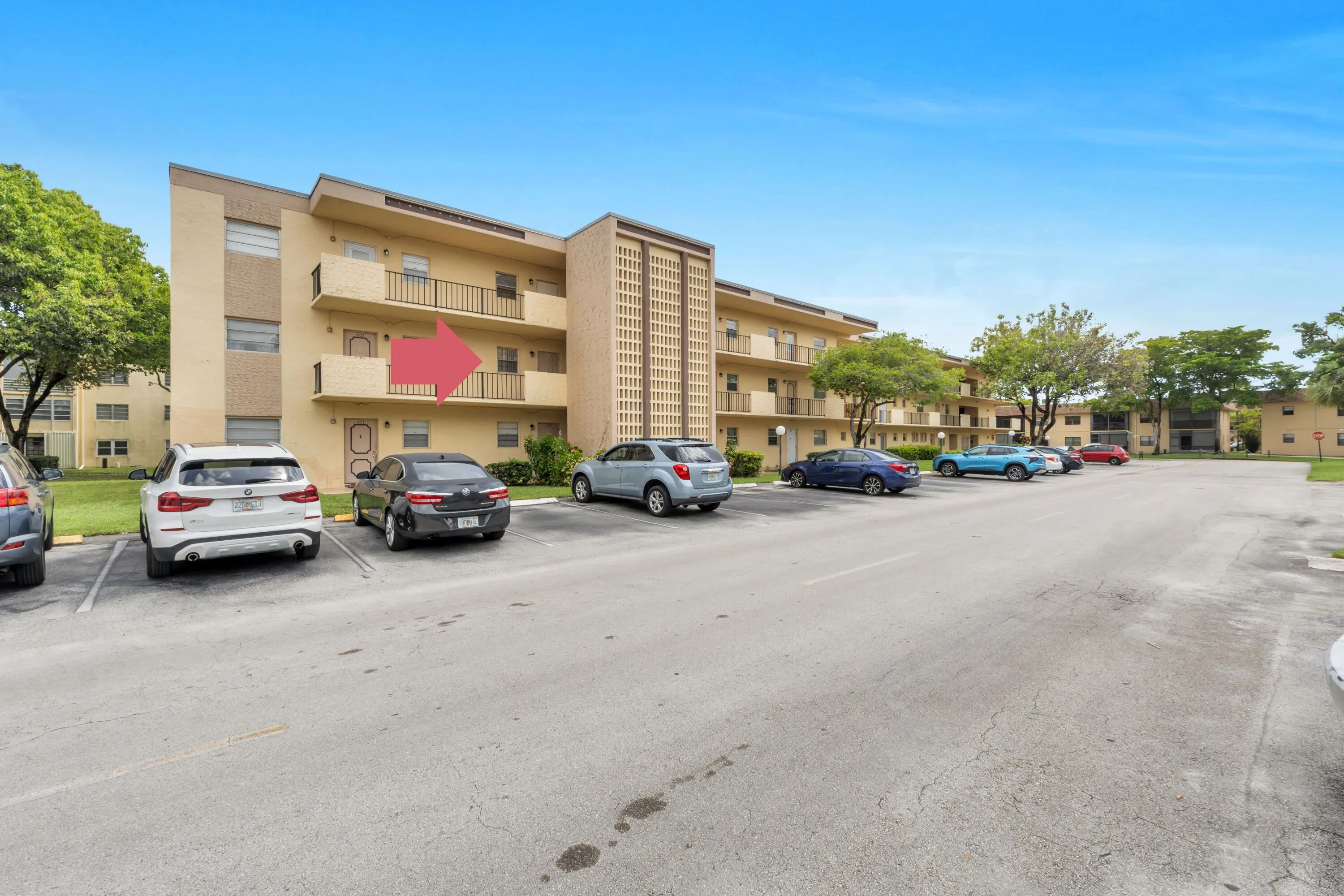 Assigned parking space #5 is directly in front of the building stairway leading to unit 202.