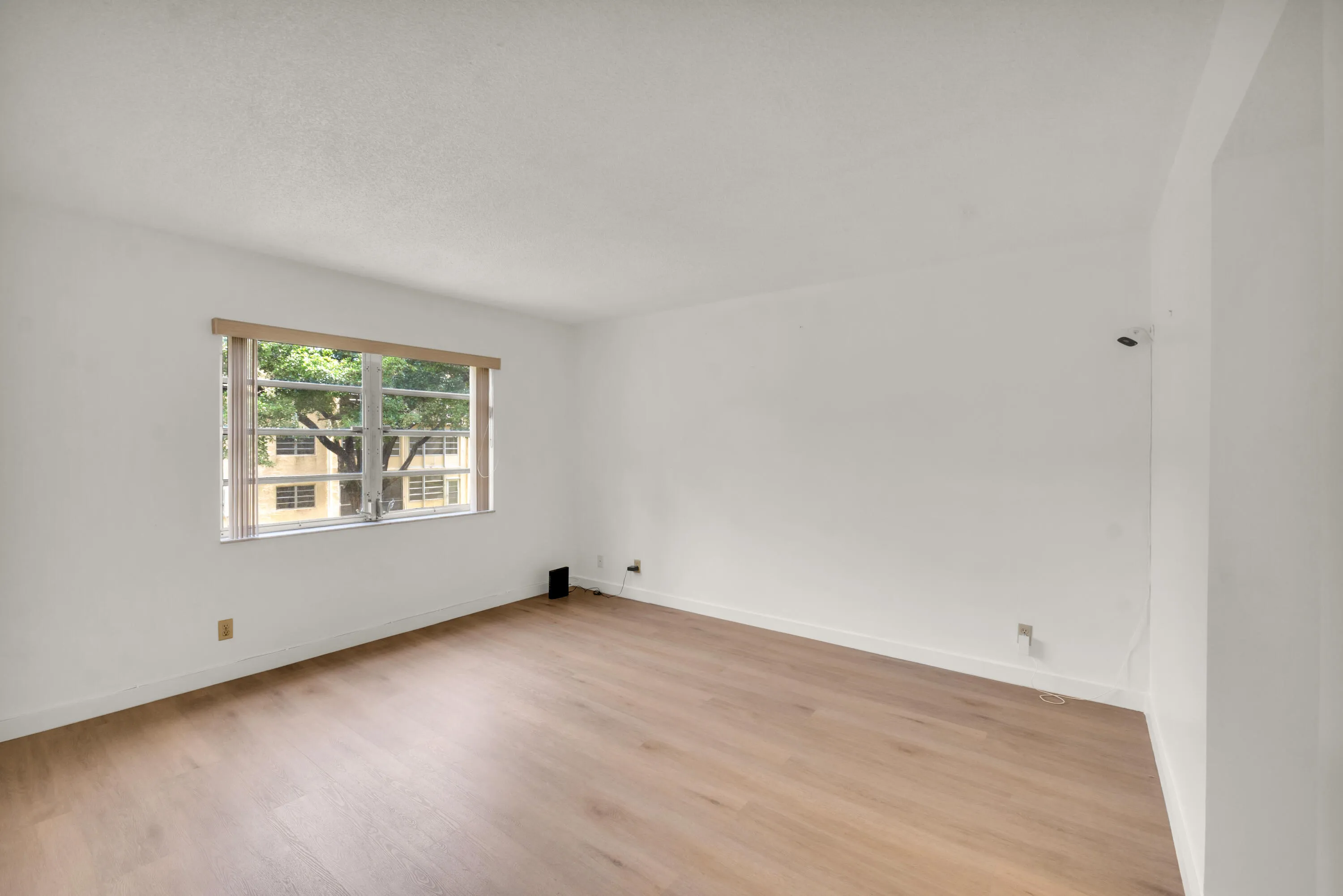 Spacious primary bedroom featuring luxury vinyl flooring.