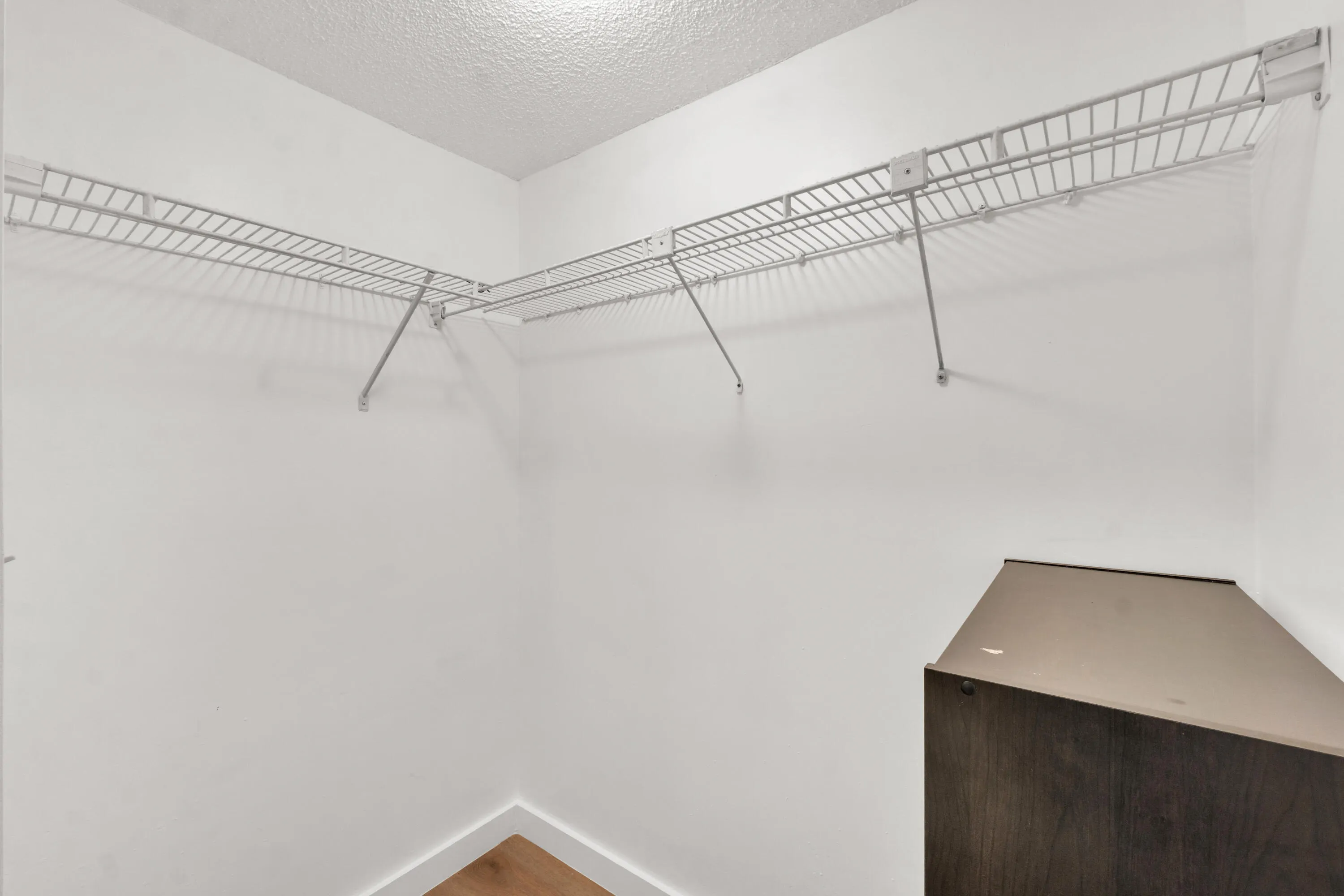 Luxury vinyl floors extend into the primary bedroom walk in closet.