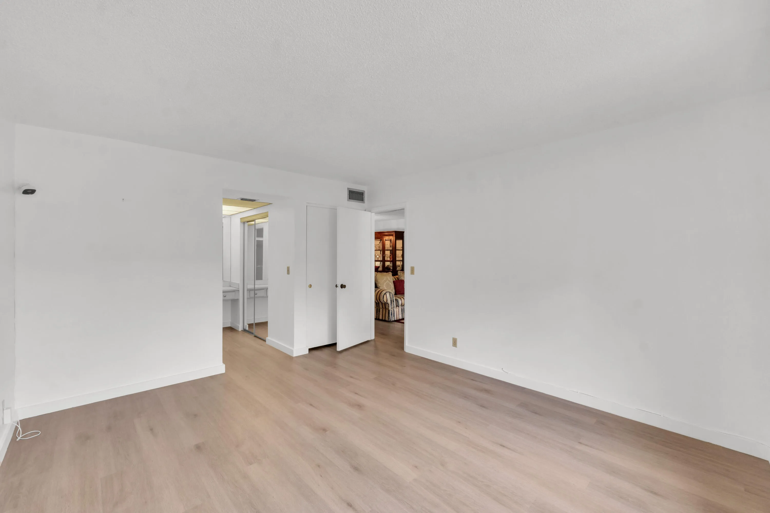 Spacious primary bedroom featuring luxury vinyl flooring.