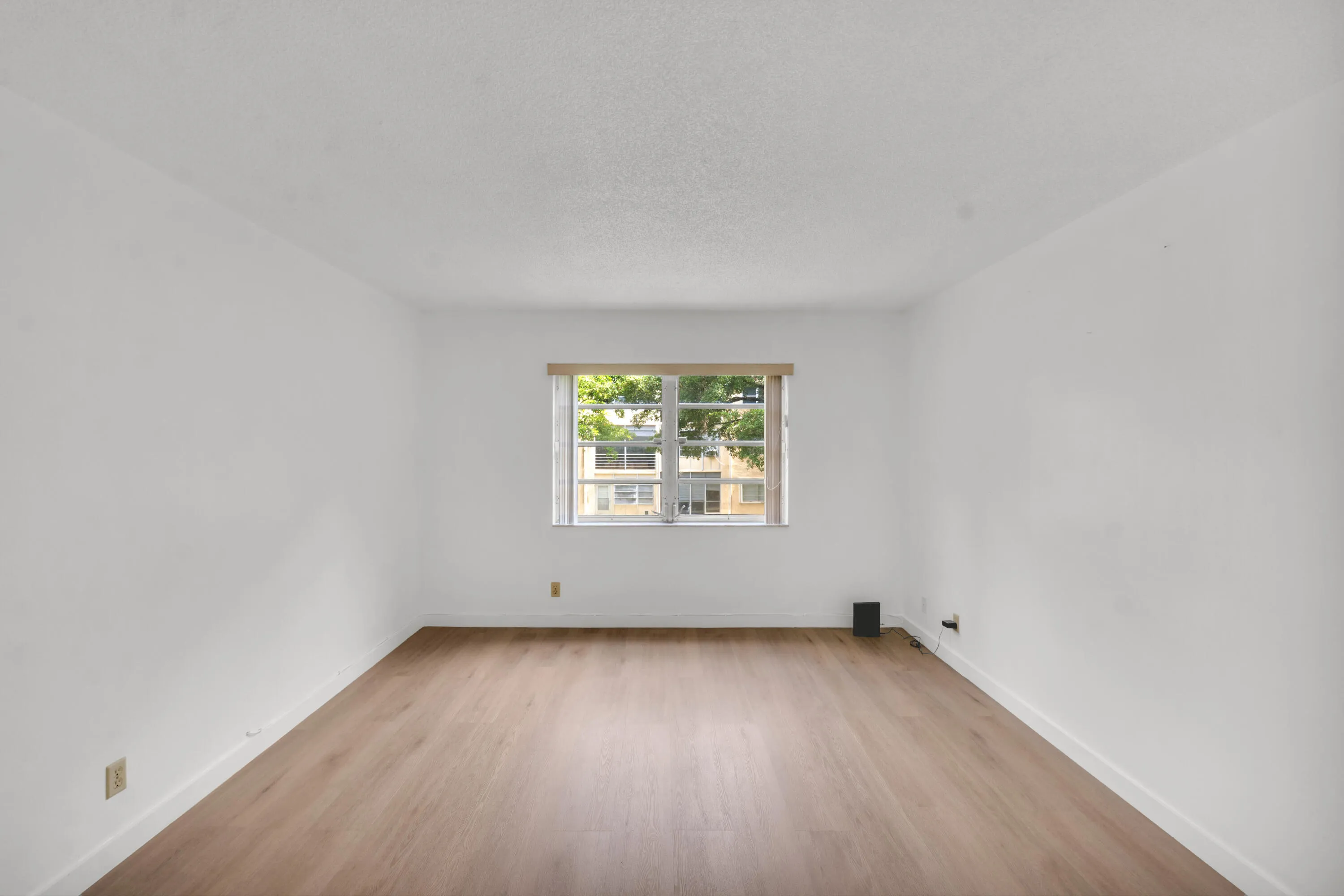 Spacious primary bedroom featuring luxury vinyl flooring.