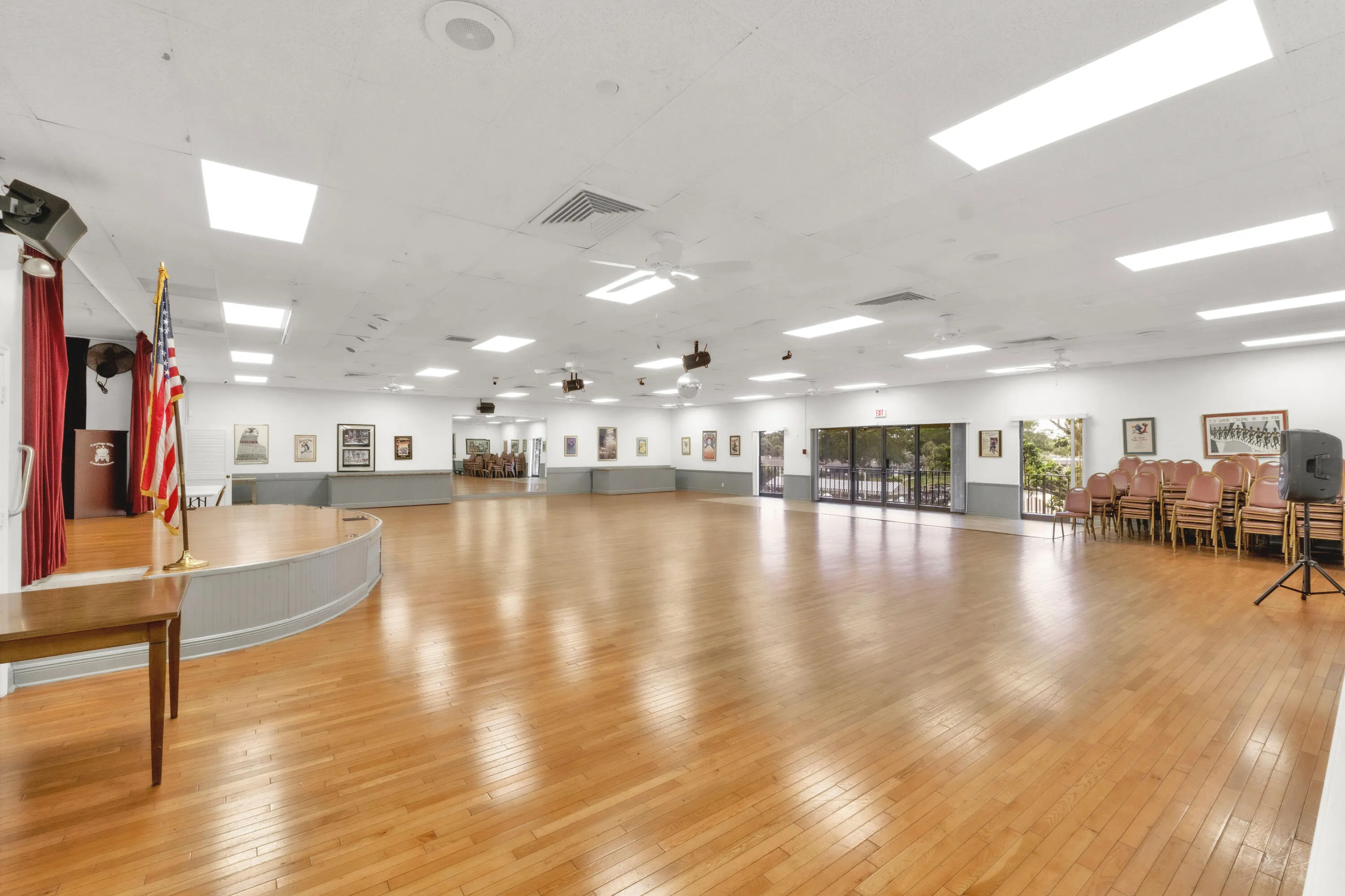 The events hall features a stage and overlooks the community pool deck.