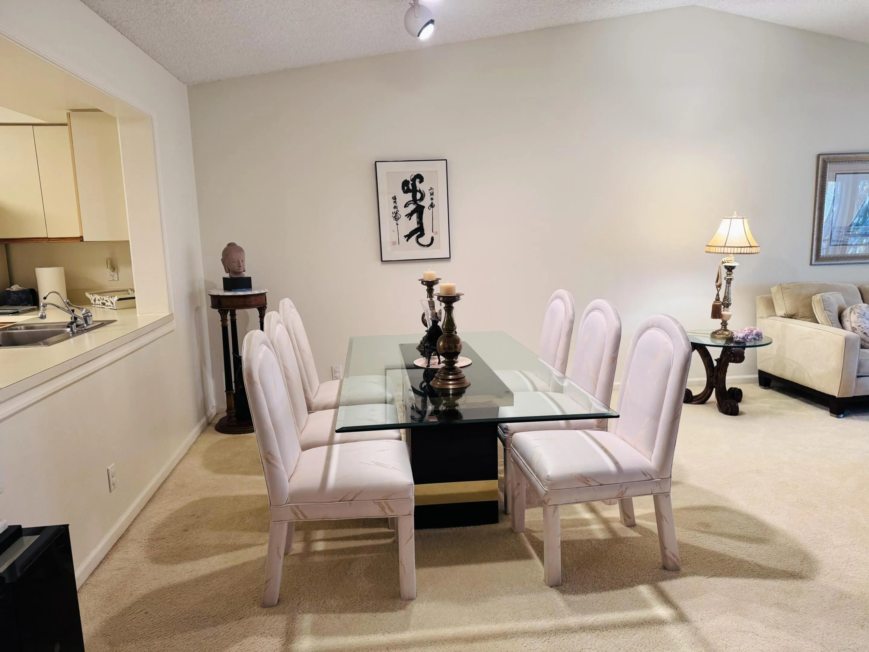 Vaulted ceiling dining area featuring a glass-top dining table