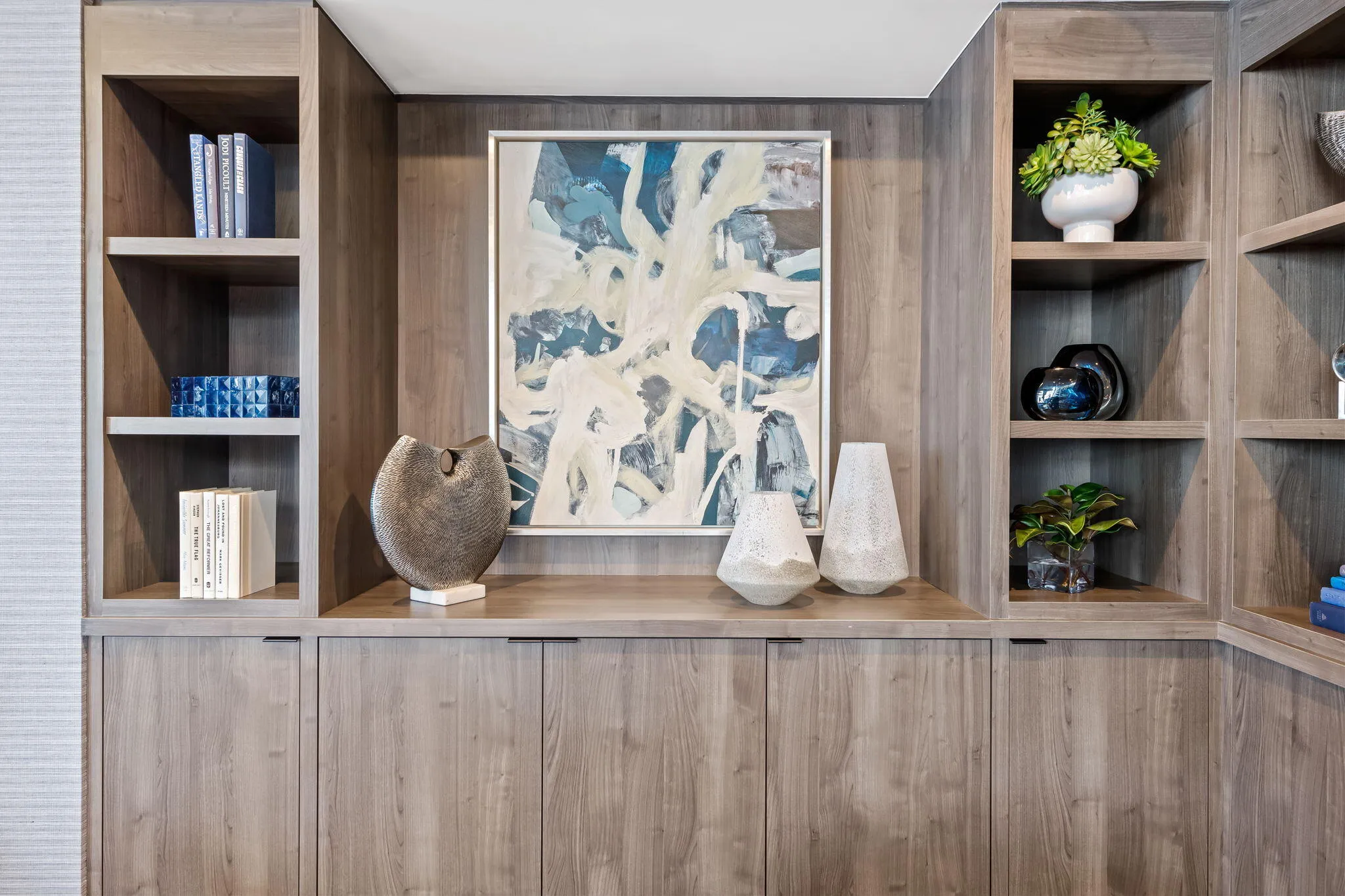 Built-in cabinetry featuring open shelving and integrated closed storage