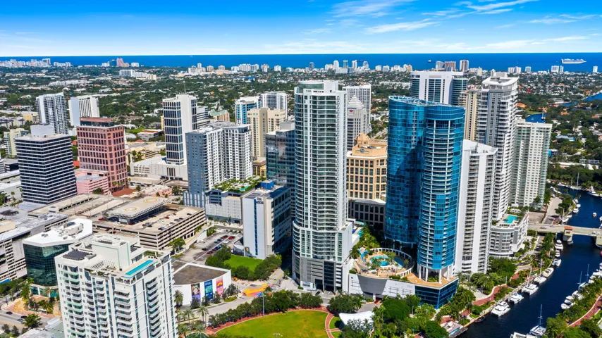 Aerial perspective highlighting high-rise architecture, proximity to waterways, and urban density