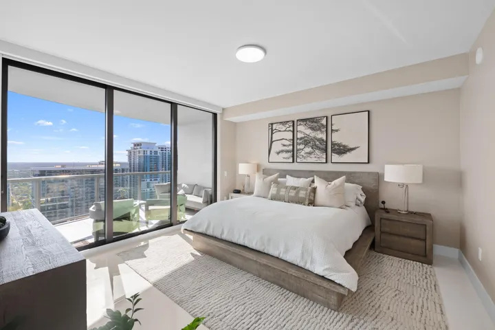 Spacious room featuring floor-to-ceiling sliding glass doors opening to a balcony