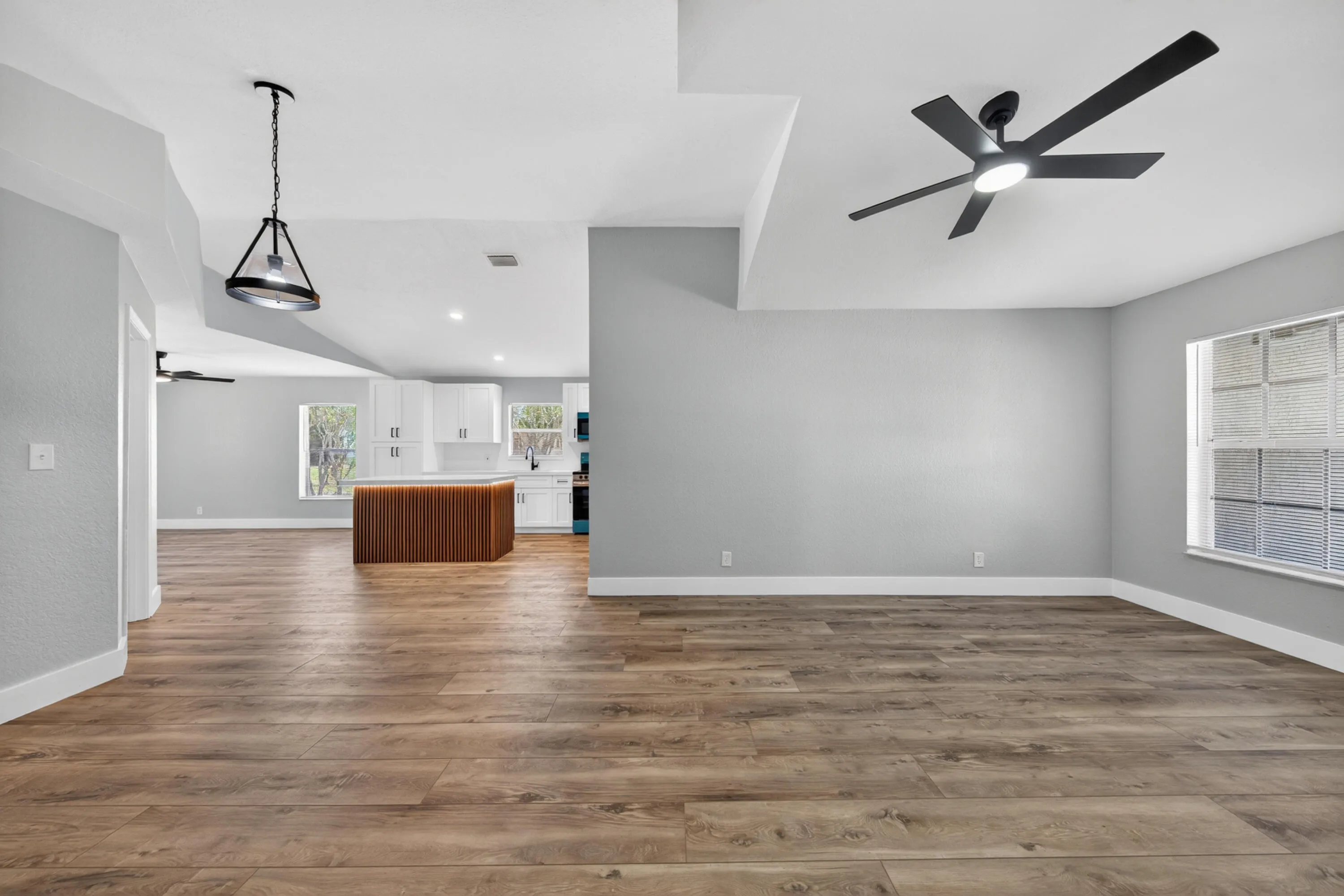 Spacious main living area with updated flooring and natural light