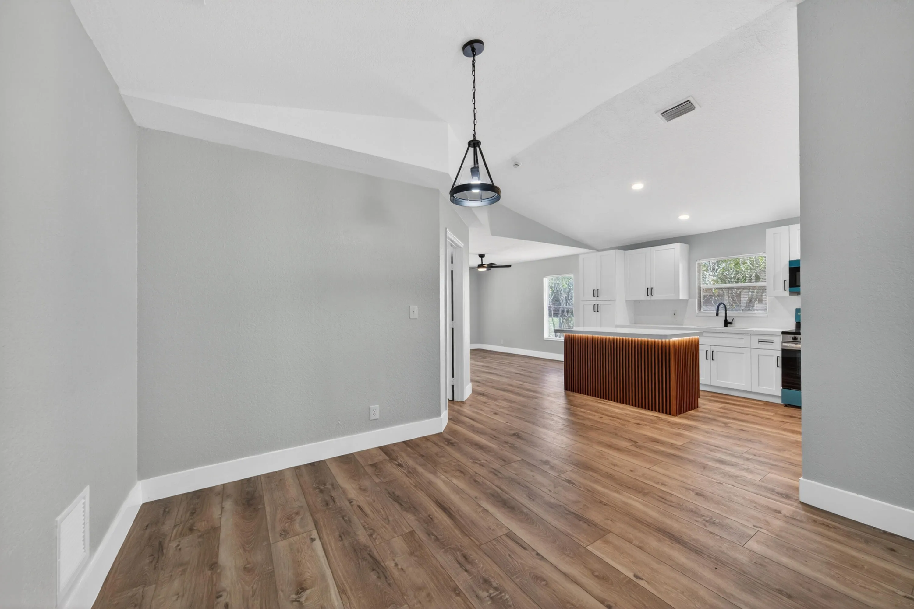 View showing the seamless flow between the main living area and kitchen