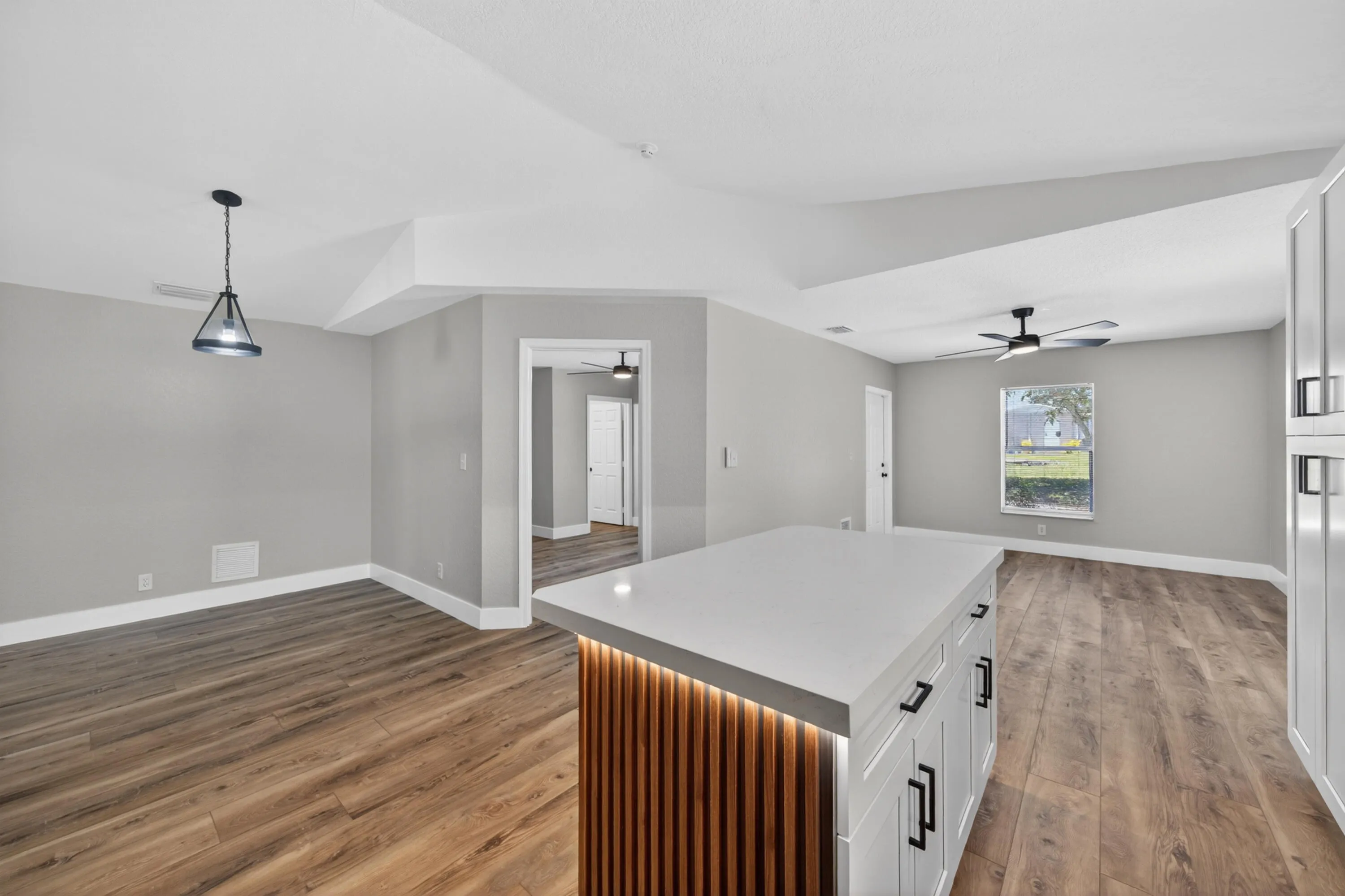 Open-concept layout connecting the kitchen, dining, and living areas