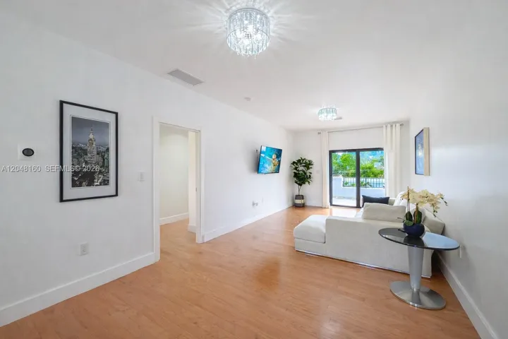 oversized landing and recreation area leading to second floor terrace overlooking back yard.