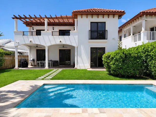 back yard with pool and covered terrace.