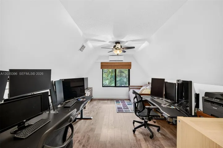 Upstairs Bedroom, currently being used as an office / guest room, with Mini Split HVAC and view to pool area
