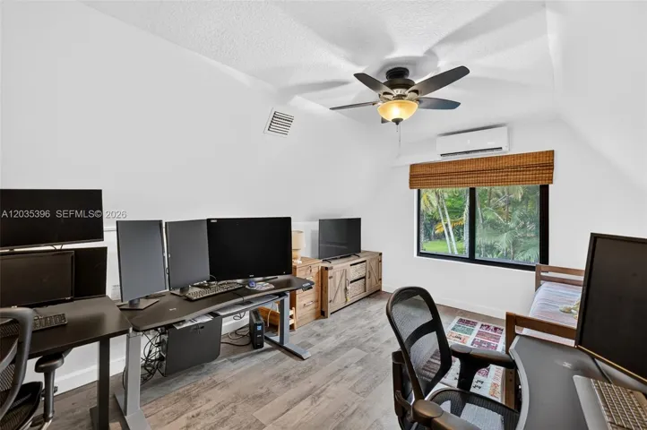 Upstairs Bedroom, currently being used as an office / guest room, with Mini Split HVAC and view to pool area
