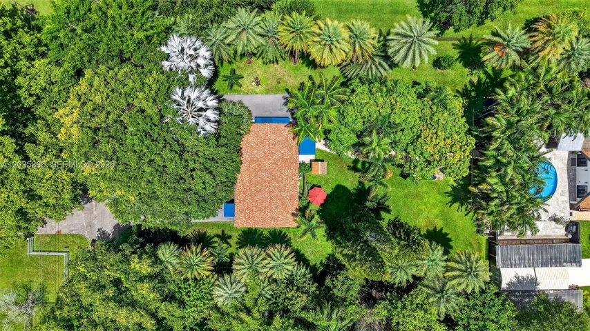 Grounds. Main house on right and guest house on left in mature garden setting